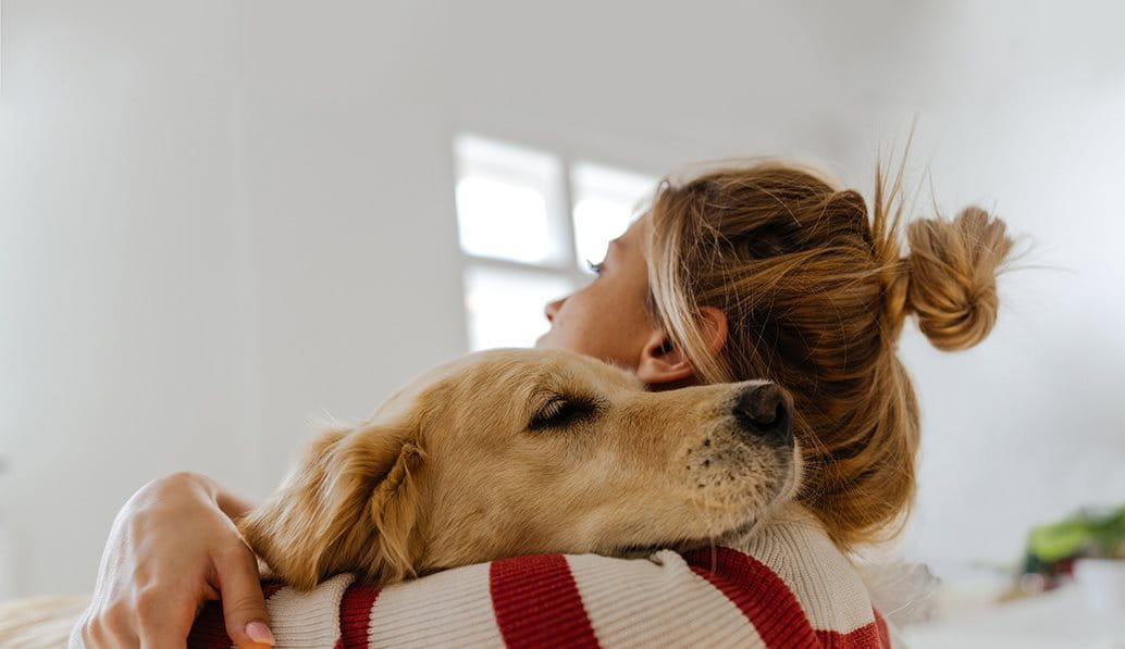Young woman cuddling pet dog