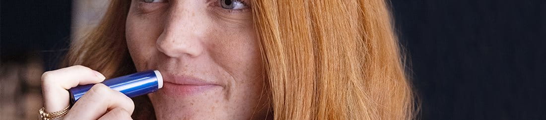 woman using Aquaphor Lip Repair