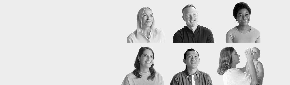 Diverse group of people smiling in black and white.