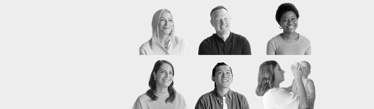 Diverse group of people smiling in black and white.