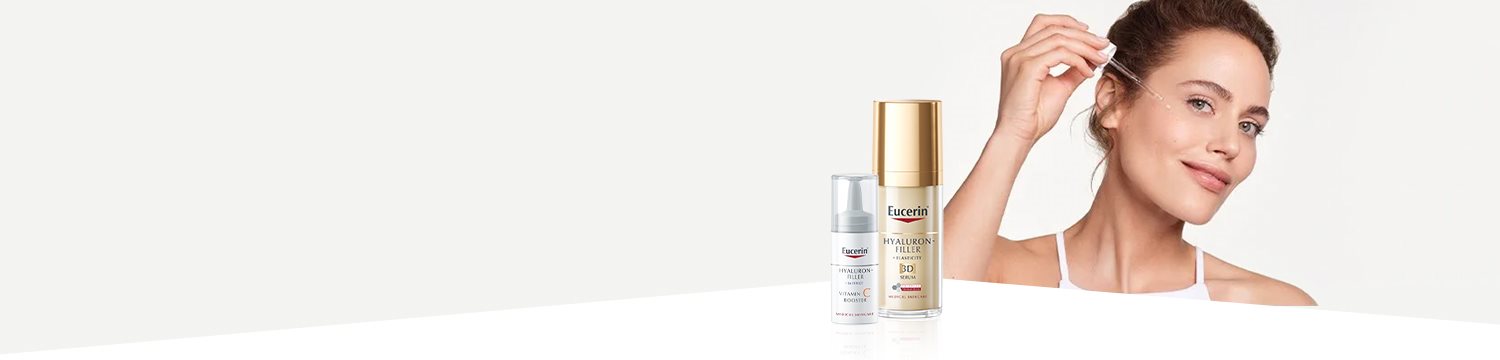 Žena používající sérum na pleť a dva Eucerin produkty