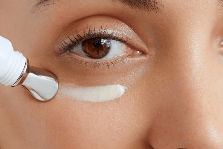 Woman applying eye cream