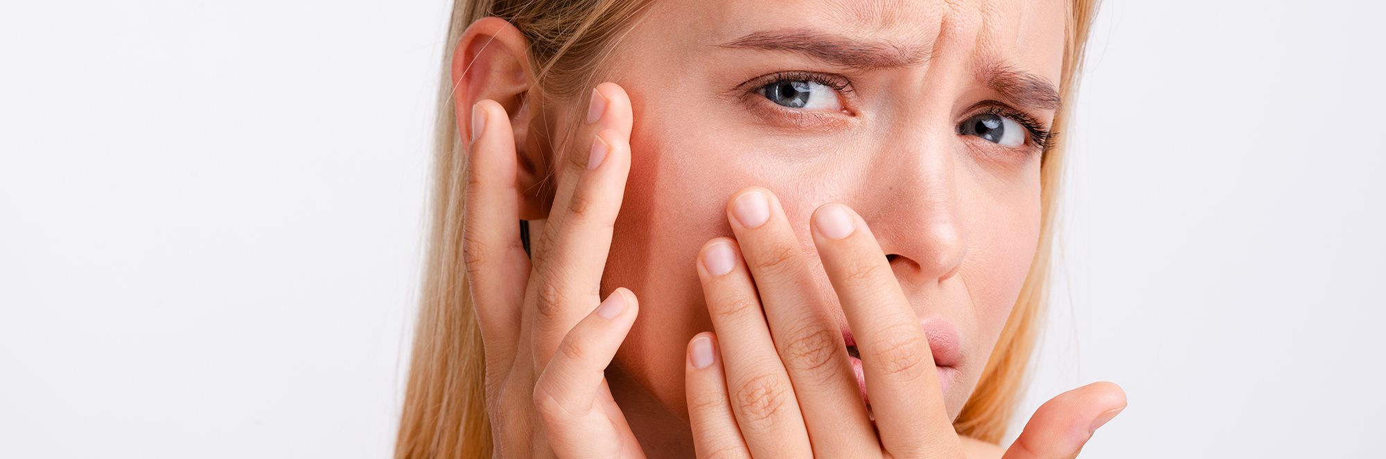 woman touching dry skin on face