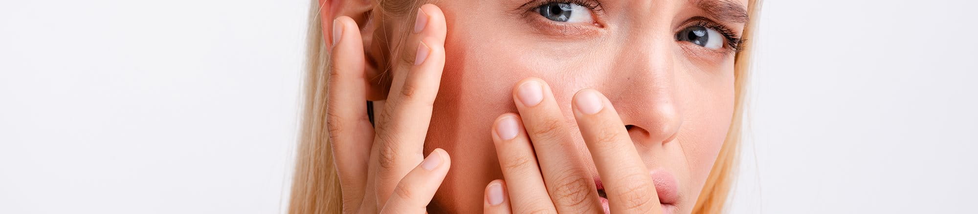 woman touching dry skin on face