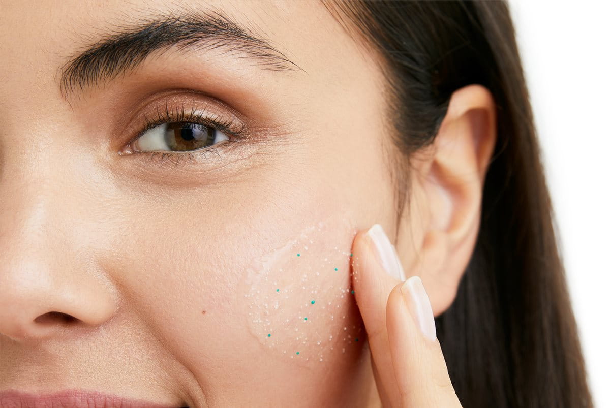 woman showing how to exfoliate face