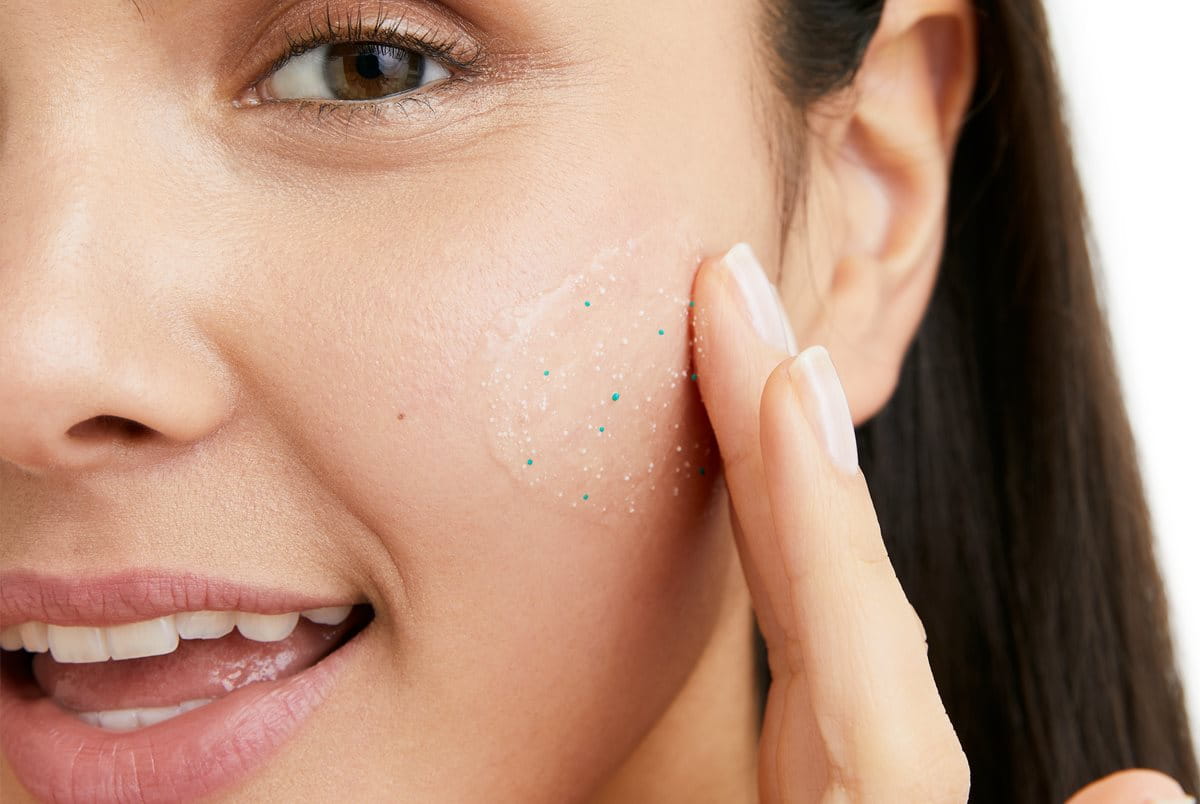 woman showing how to exfoliate face