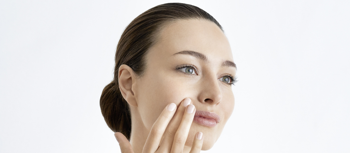 woman exfoliating face