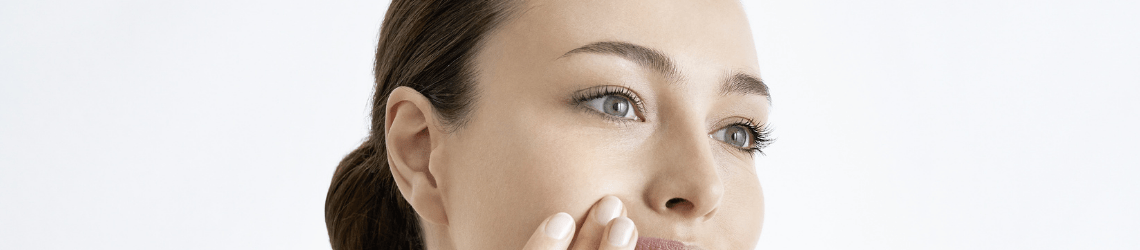 woman exfoliating face