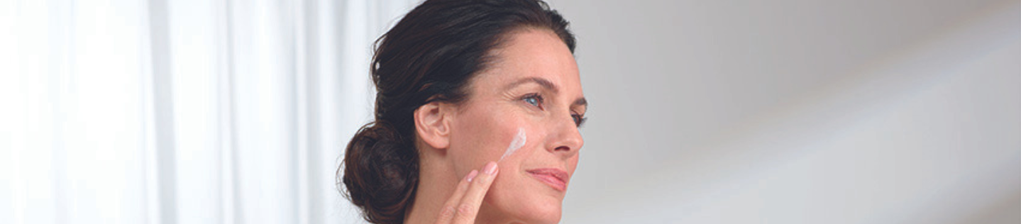 Woman layering skincare