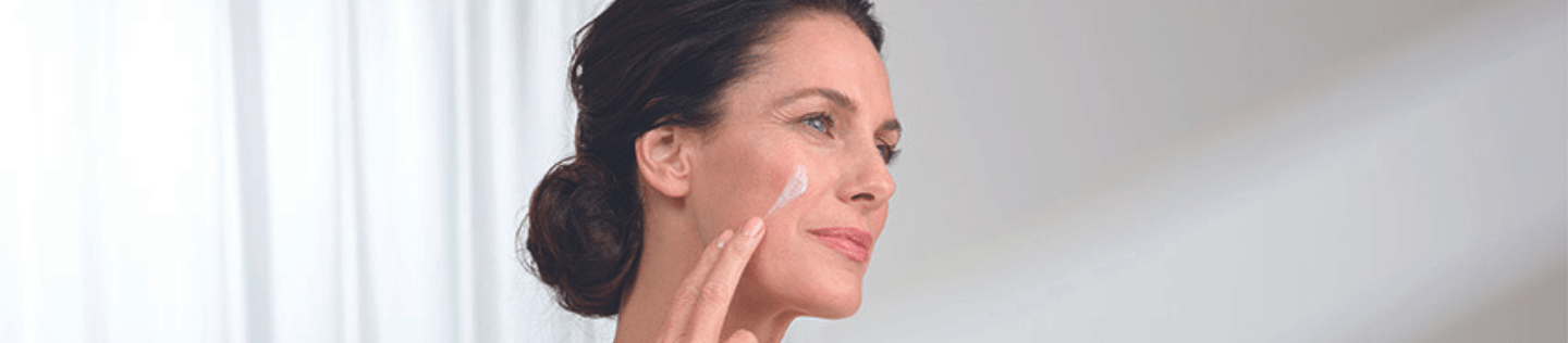 Woman layering skincare