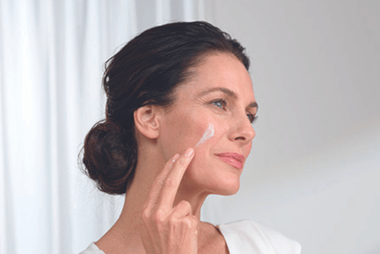 Woman layering skincare