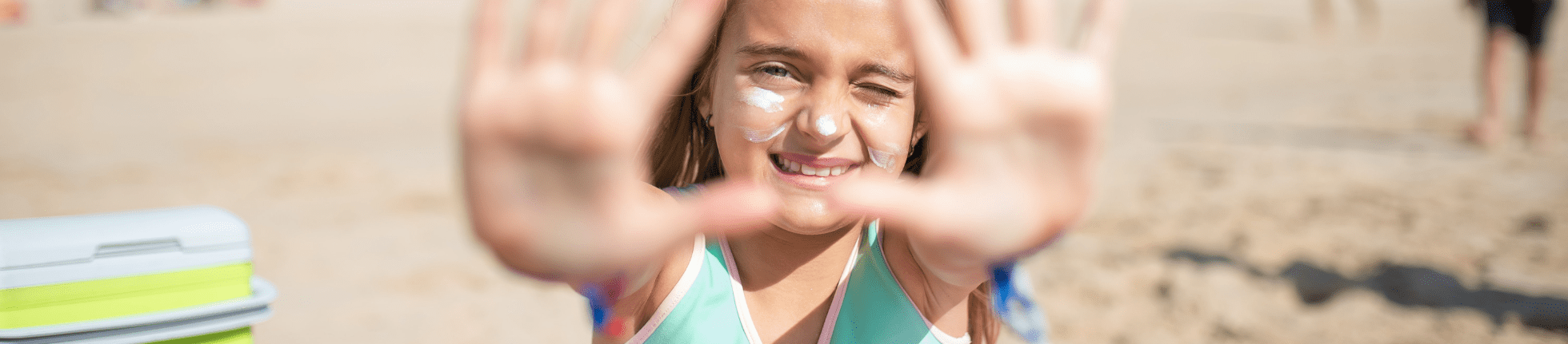 Girl with sunscreen in face