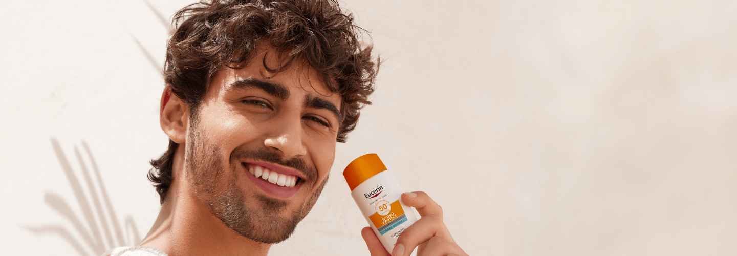 man using Eucerin sunscreen
