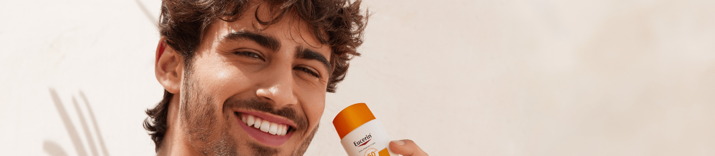 man using Eucerin sunscreen