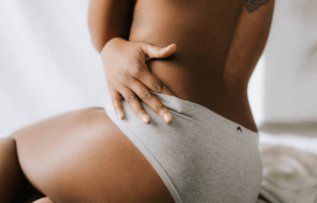 Woman touching stretch marks