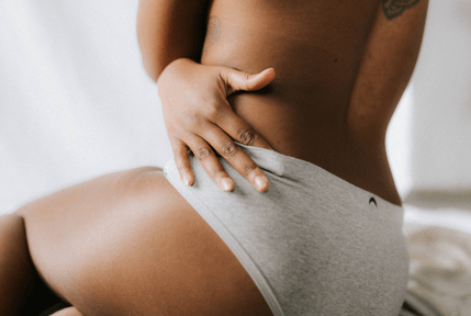 woman touching stretch marks