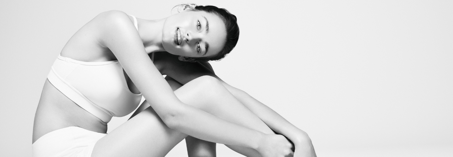 A women applying moisturiser to itchy legs after a shower