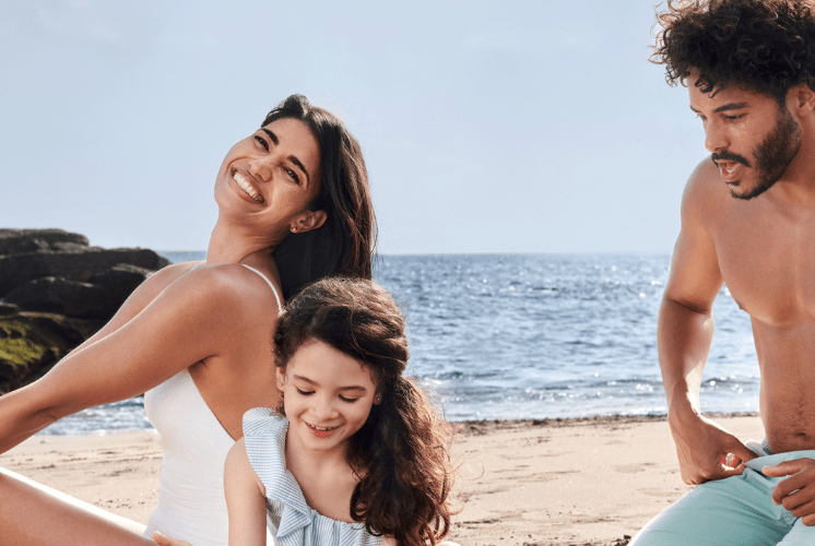 Mother and girl put sunscreen in body
