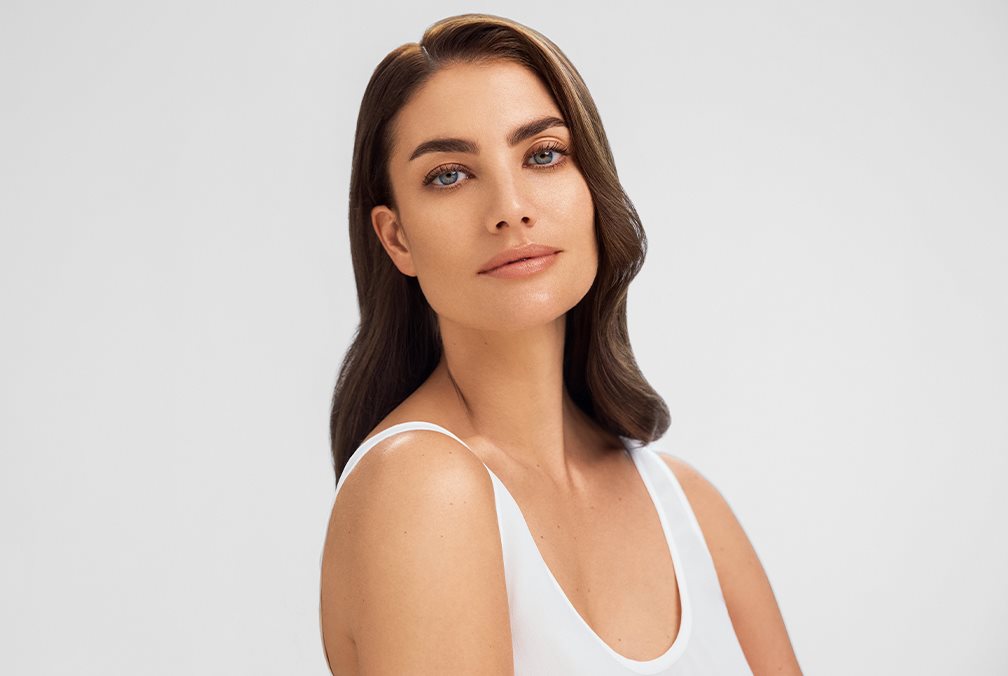 A woman with makeup applied on her acne prone skin - Eucerin