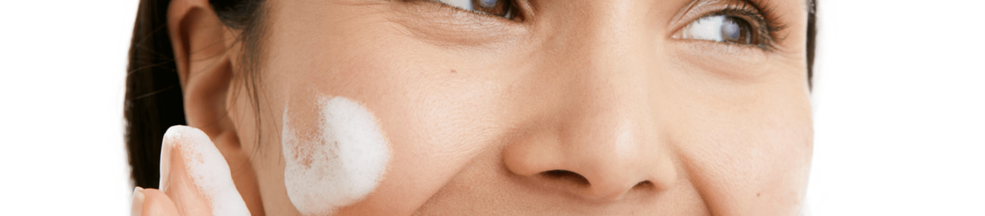 Leende kvinna mot en vit bakgrund