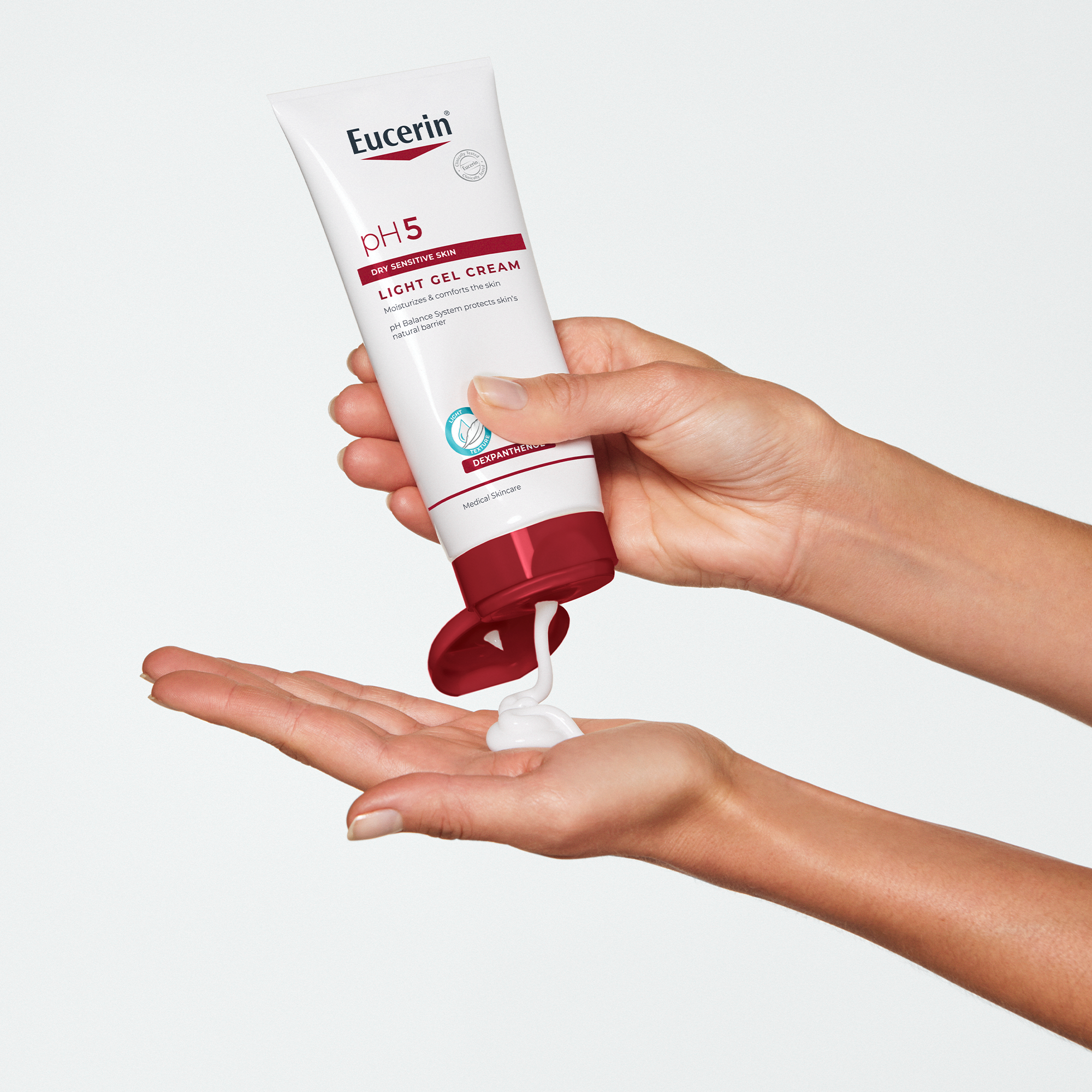 Hand holding open light gel cream jar