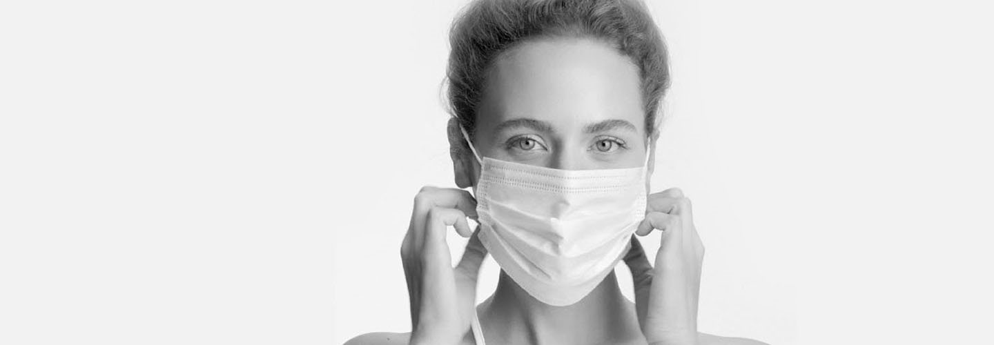 Woman wearing a face mask to prevent maskne.
