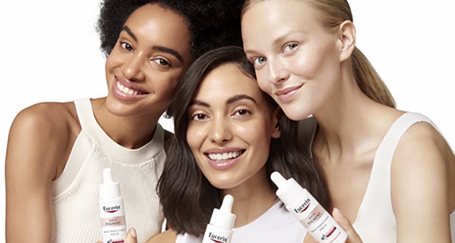 Tre kvinnor som håller Anti-Pigment Skin Perfecting serum som ger lyster och glow