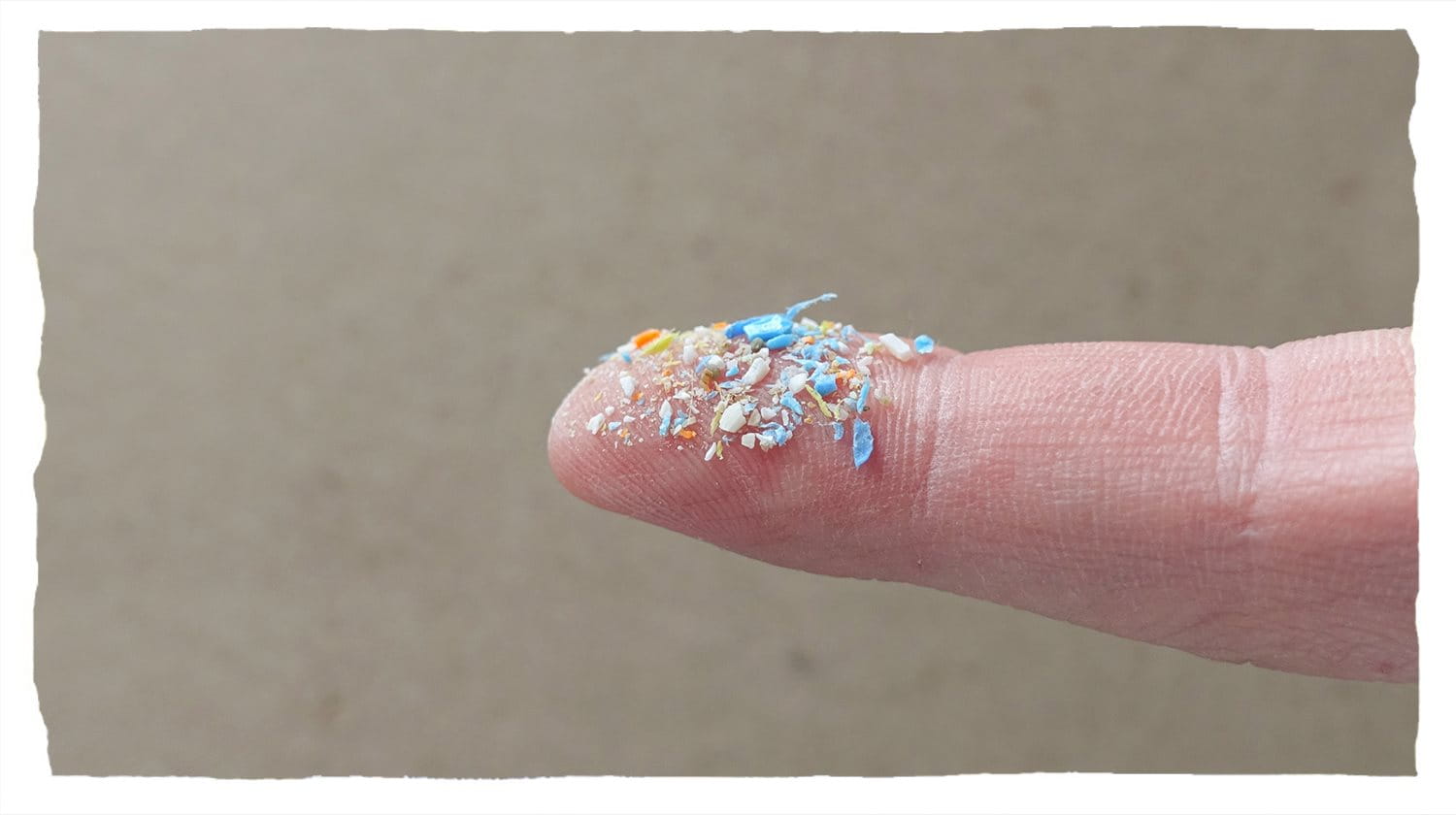 Plastic fragments visible on the tip of a finger