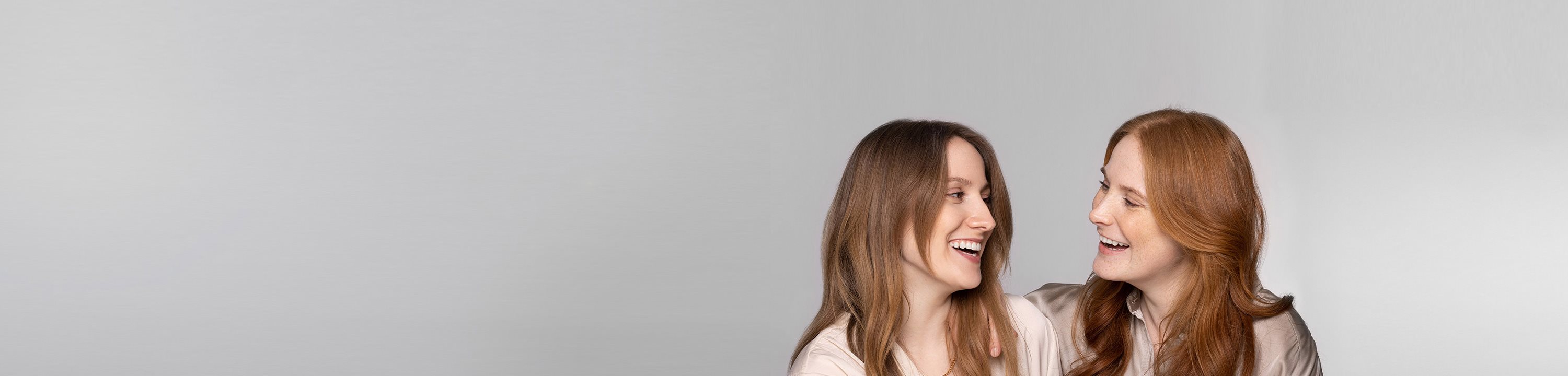 Zwei Frauen lachen sich an