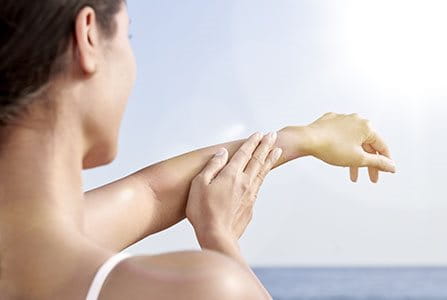 Mujer cuidando su piel de los efectos de los rayos UV en la piel