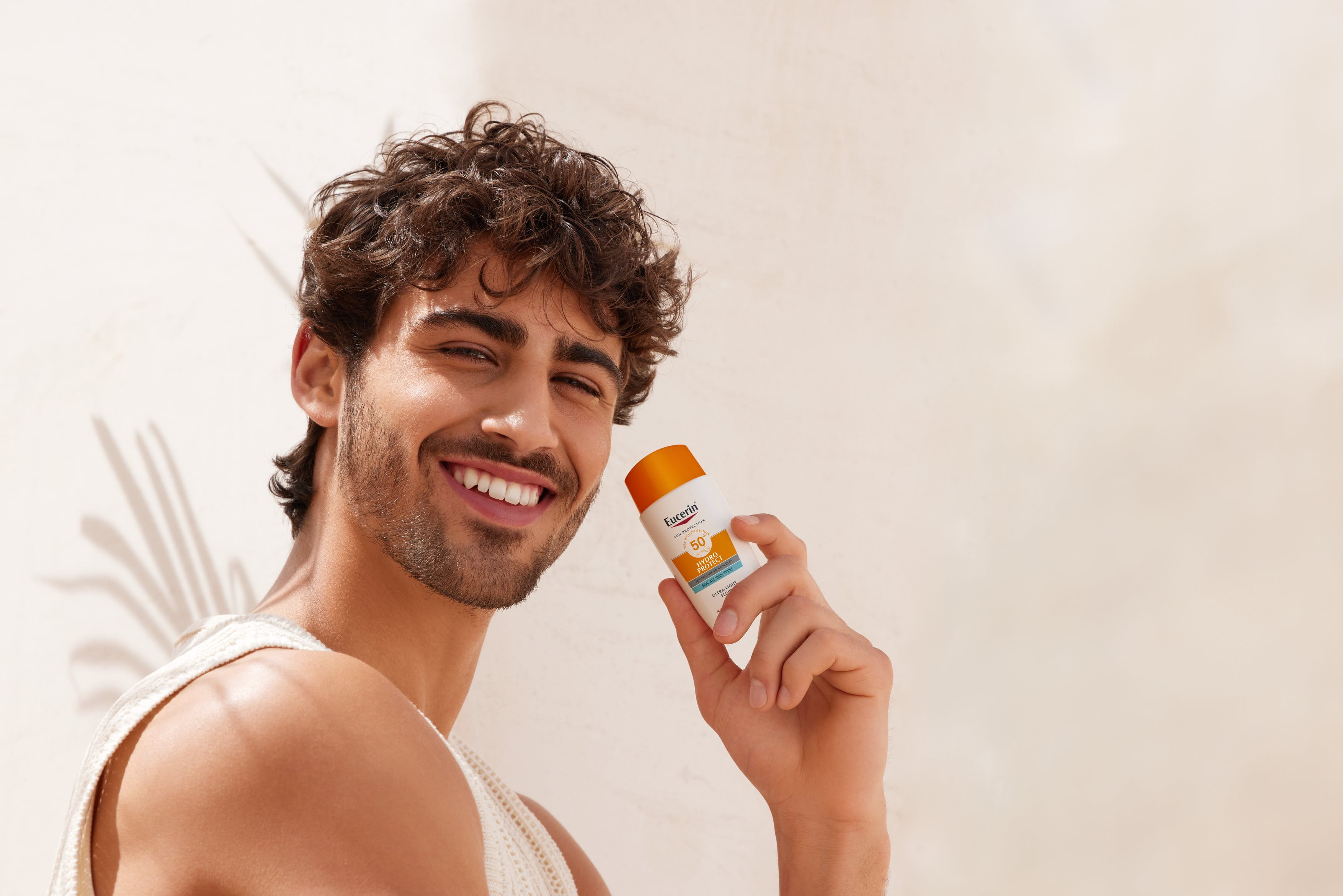 man holding sunscreen