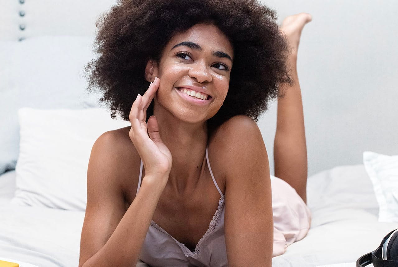 kvinna smörjer in ansiktet med kräm