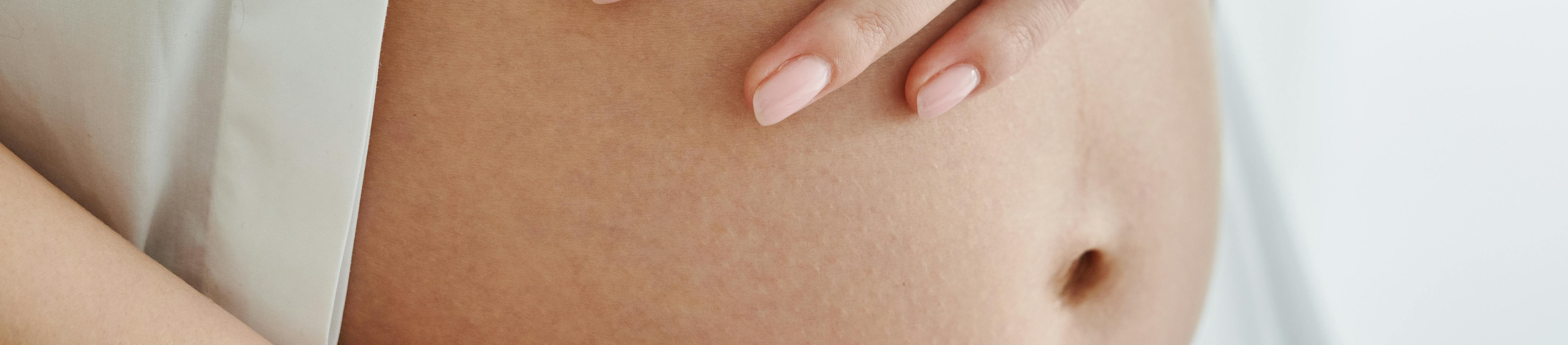 a pregnant woman holding her belly