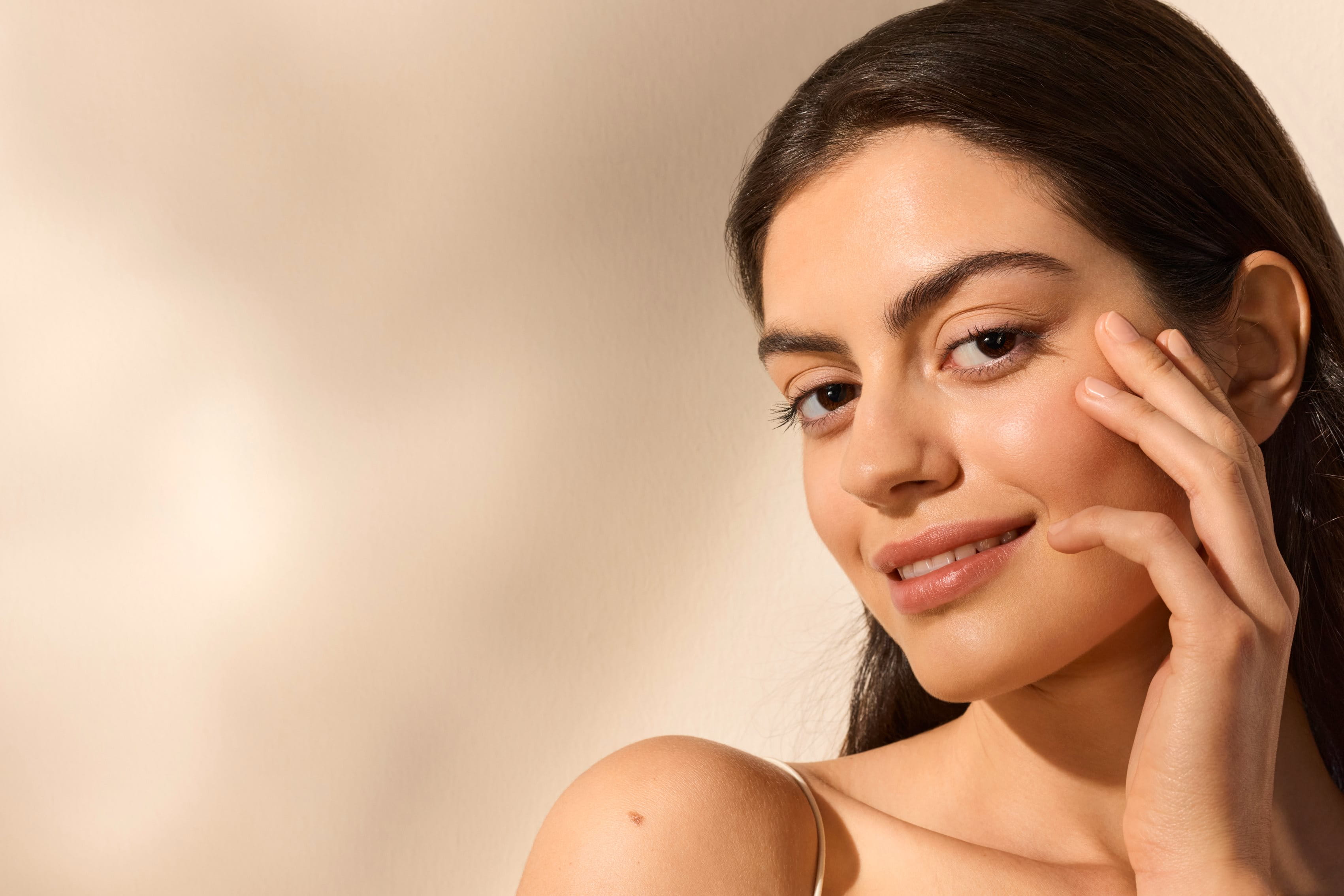 a woman with firm, smooth, radiant skin under the sun exposure