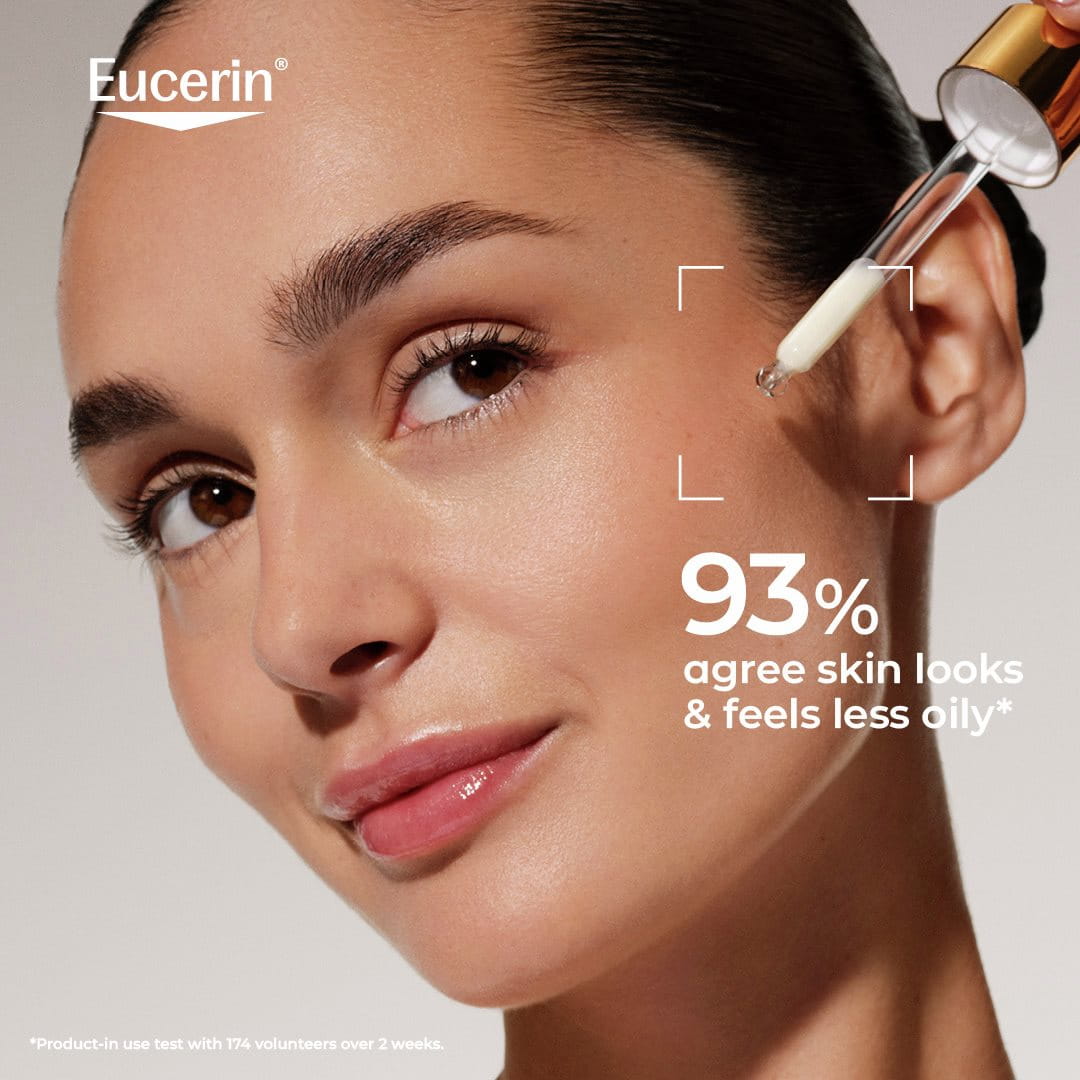 close-up of a person applying Eucerin Sun Face Oil Control Daily UV Serum SPF 50+ to her face.