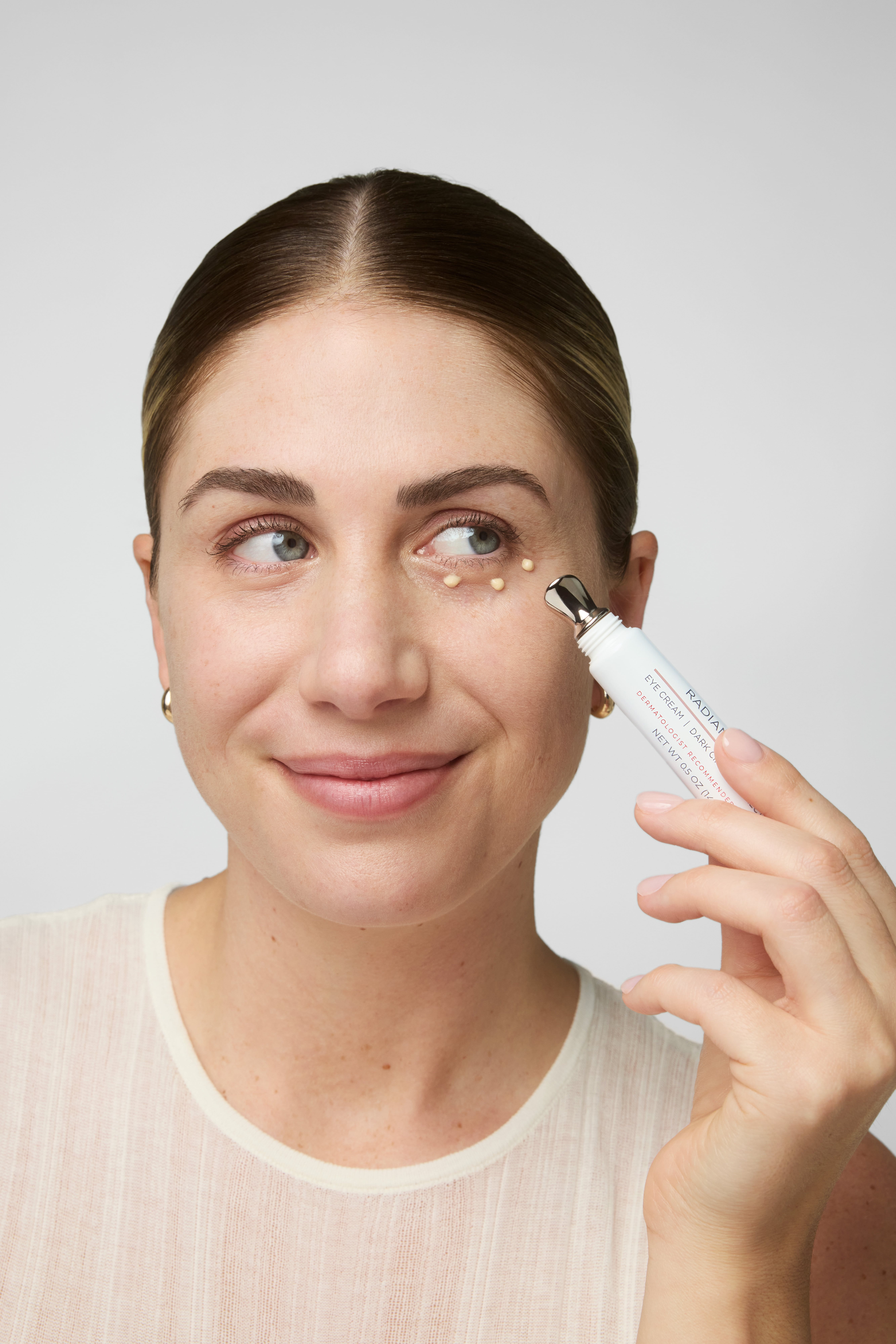 Women applying cream under the eyes