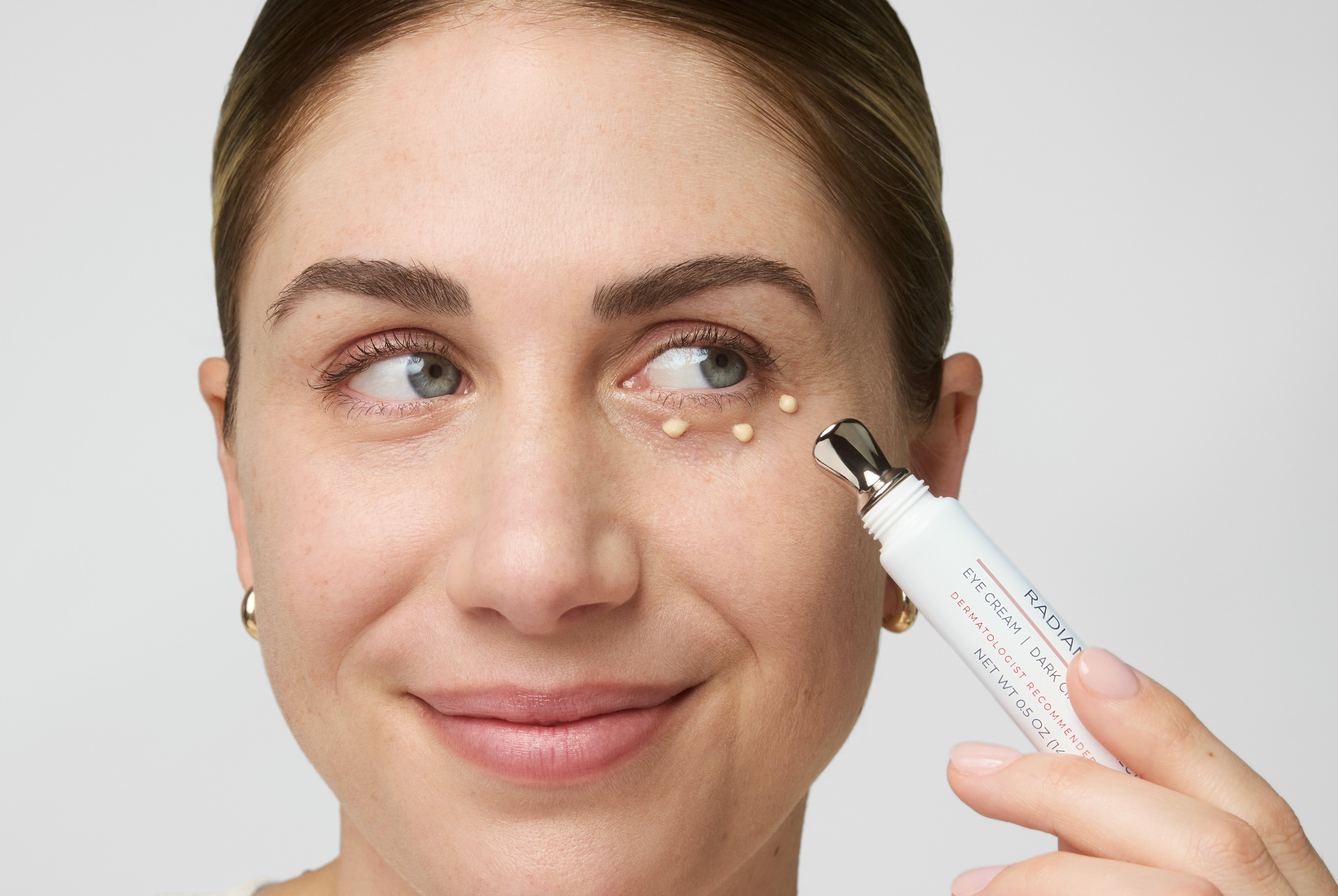 Women applying cream under the eyes