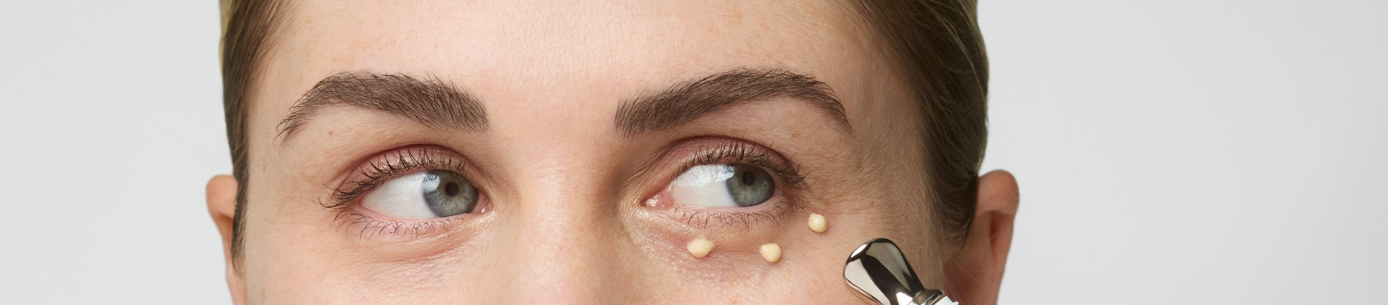 Women applying cream under the eyes