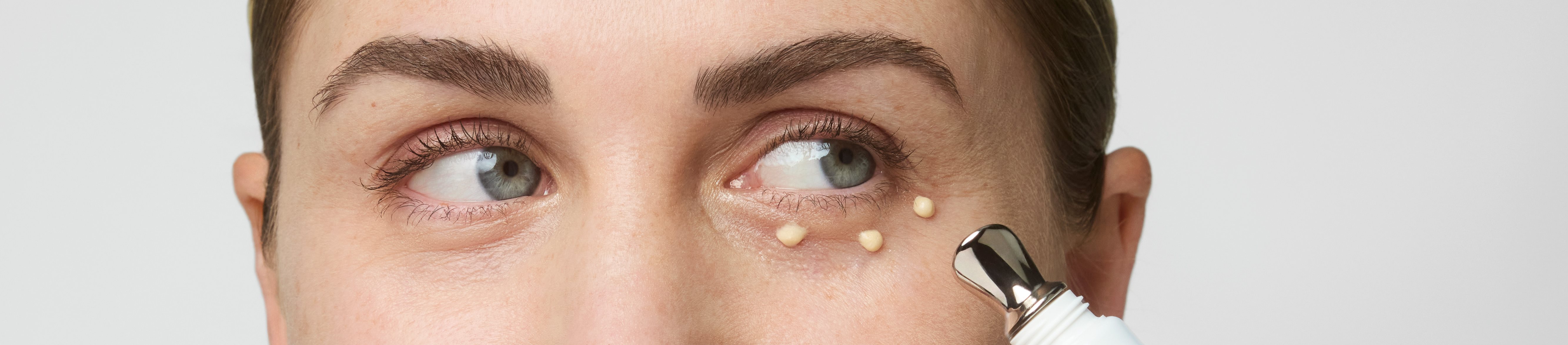 Women applying cream under the eyes