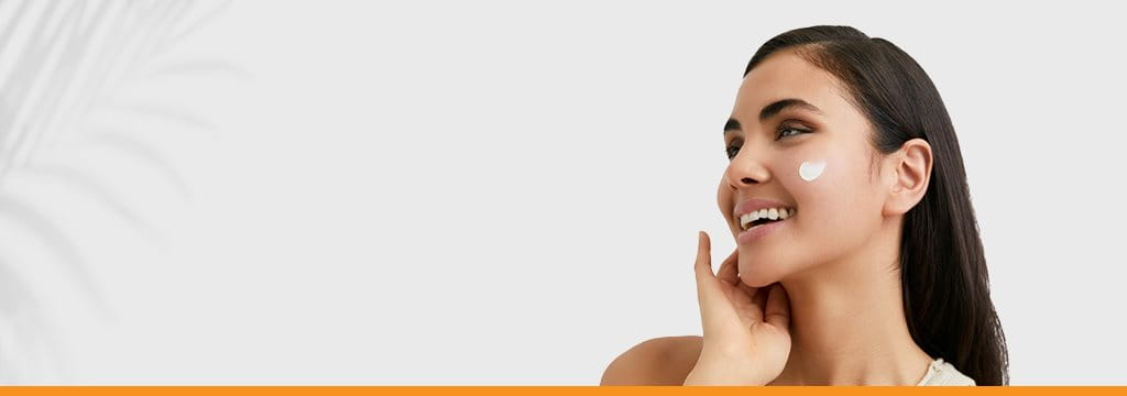 Women Applying Eucerin Sunscreen