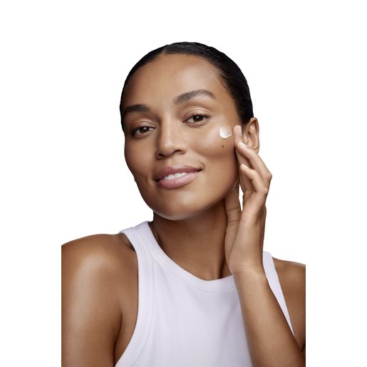 Woman using moisturizer on her face