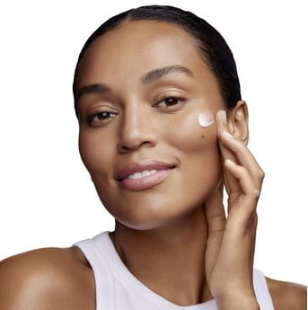 Woman using moisturizer on her face