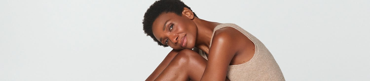 Woman resting her head on her knees