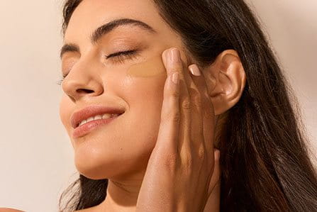 woman applying sunscreen to face