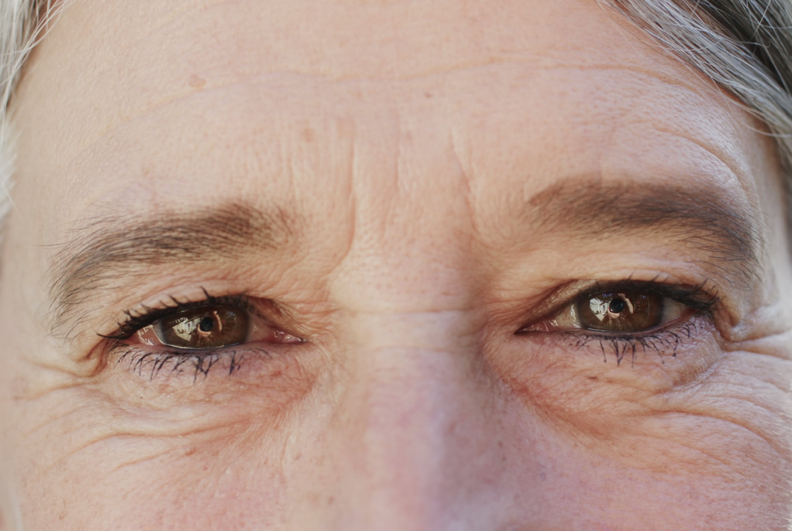a close up look of a woman with mature skin and frown lines