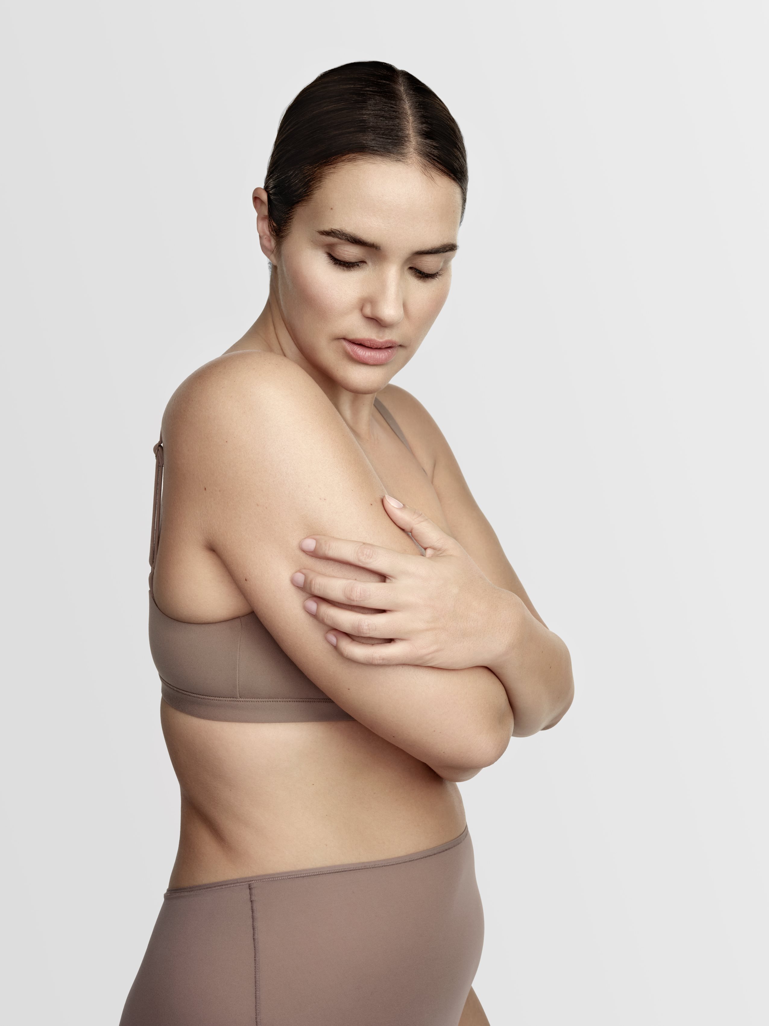 woman applying cream to arm