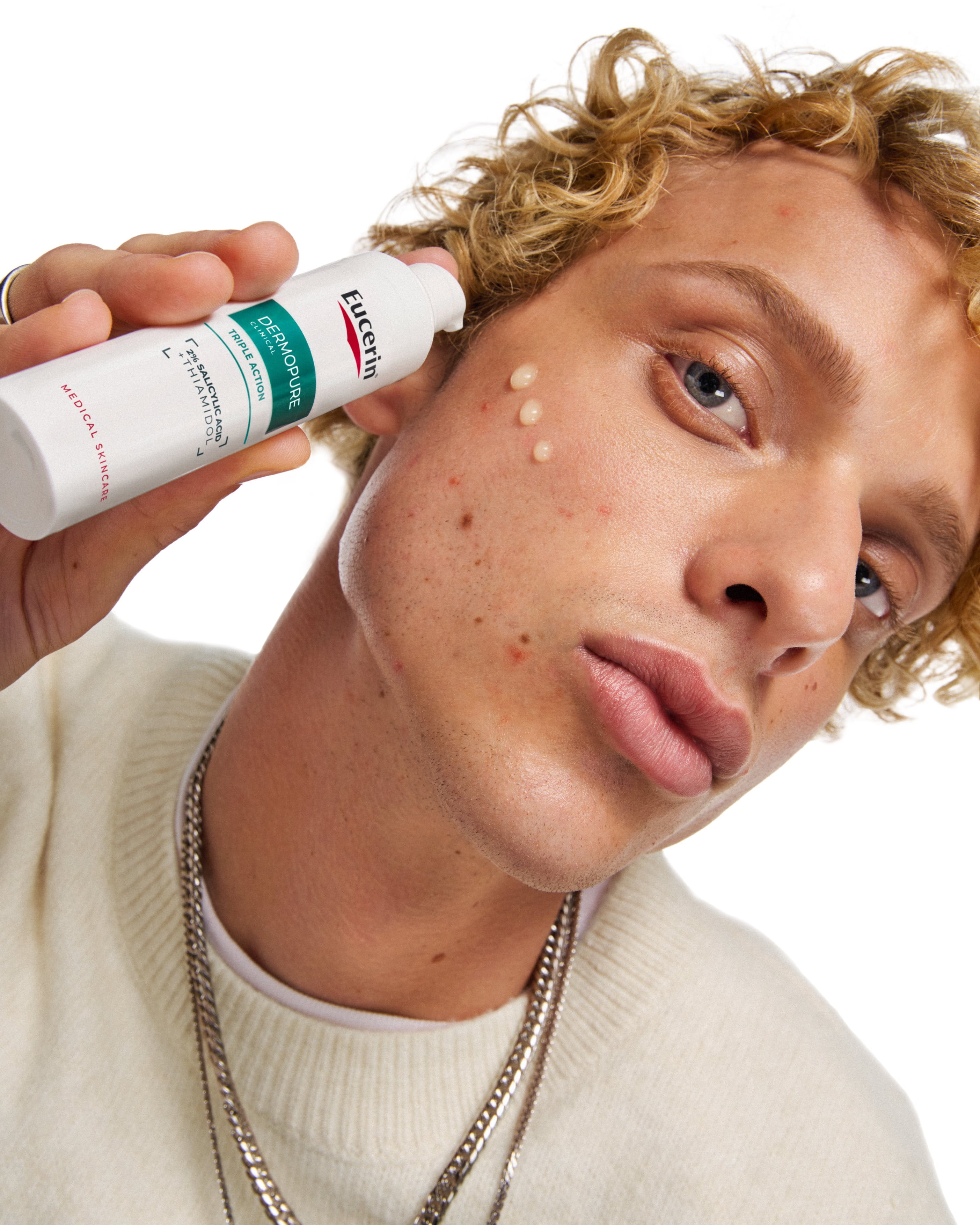 a man using eucerin dermopure triple action for blemish-prone skin