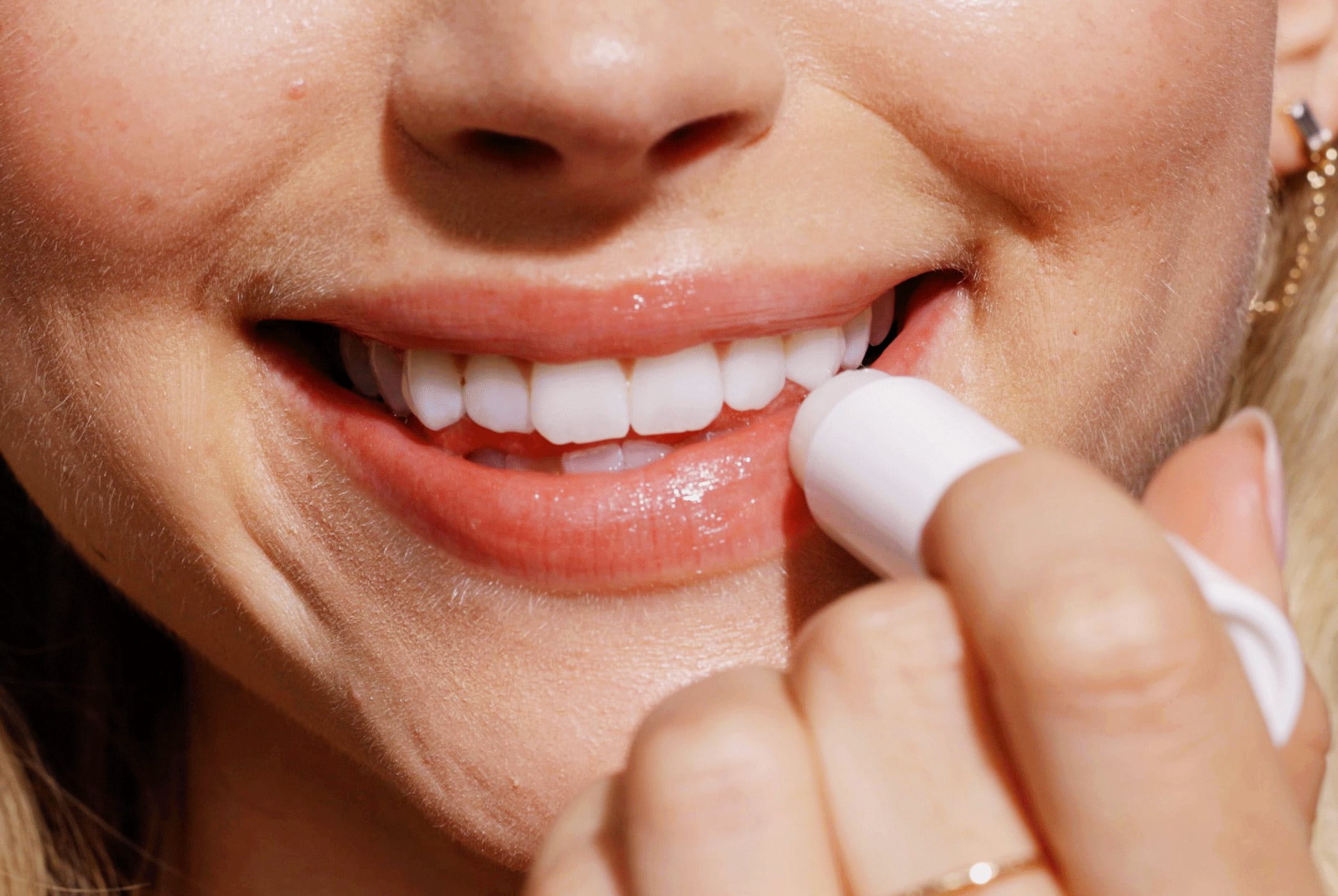 Woman applying lip balm