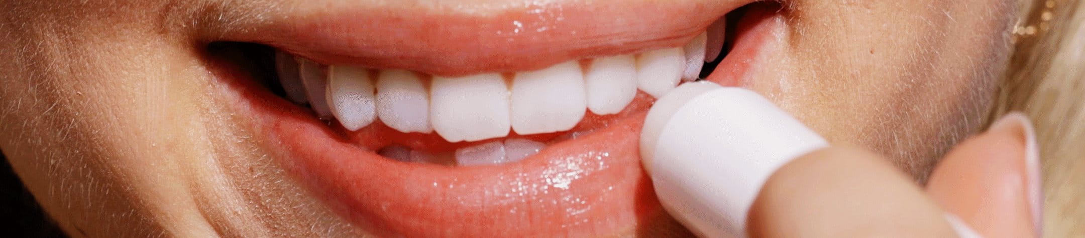 woman applying lip balm