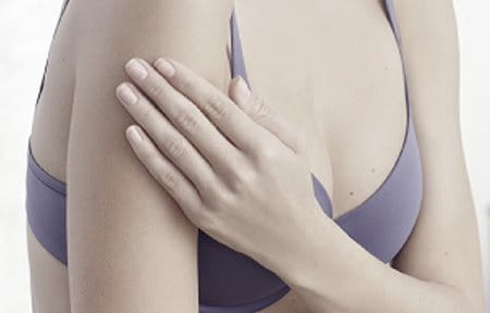 Women wearing a bra, touching her right arm